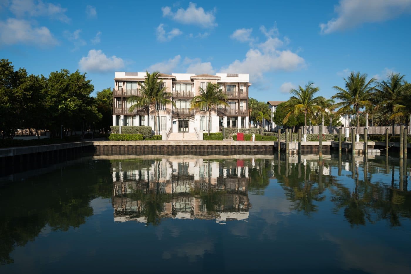 Finished canal-front residence at Marlin Bay reflected in still water, Marathon FL